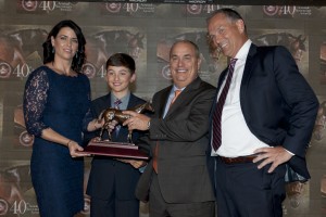 Trainer Mark Casse with his wife Tina and their son Colby accept the Horse of the Year award for Lexie Lou on behalf of owner Gary Barber from Jockey Club of Canada Chief Steward, Jim Lawson