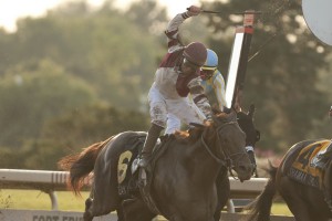 Jockey Jim McAleney celebrates as the Reade Baker Trained, Breaking Lucky, owned by Gunpowder Farms LLC, crosses the wire a neck ahead of Queen's Plate winner Shaman Ghost in the 80th running of the Prince of Wales Stakes at Fort Erie Racetrack on July 28. Michael Burns Photo