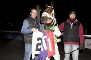 Toronto Ont. November 29,2015.Woodbine Racetrack.Jockey Eurico Da Silva holds 201 saddle cloths after Elijah captures the last race of the 2015 thoroughbred racing season.Eurico Da Silva captures the Jockey's title at Woodbine Racetrack. (L-R) trainer Don McRae,jockey Eurico Da Silva and groom. michael burns photo